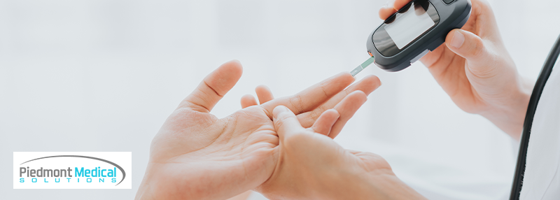 Person pricking finger to test their blood sugar level